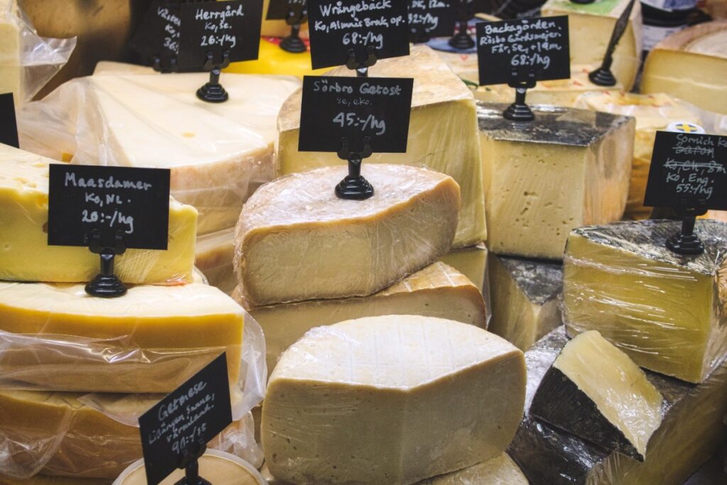 A variety of cheese for sale at the deli counter in a supermarket jpg